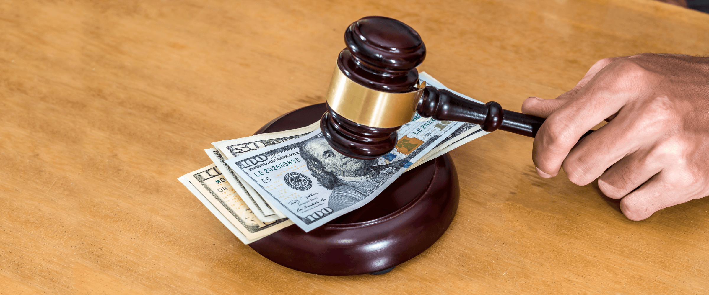 Legal gavel striking money.