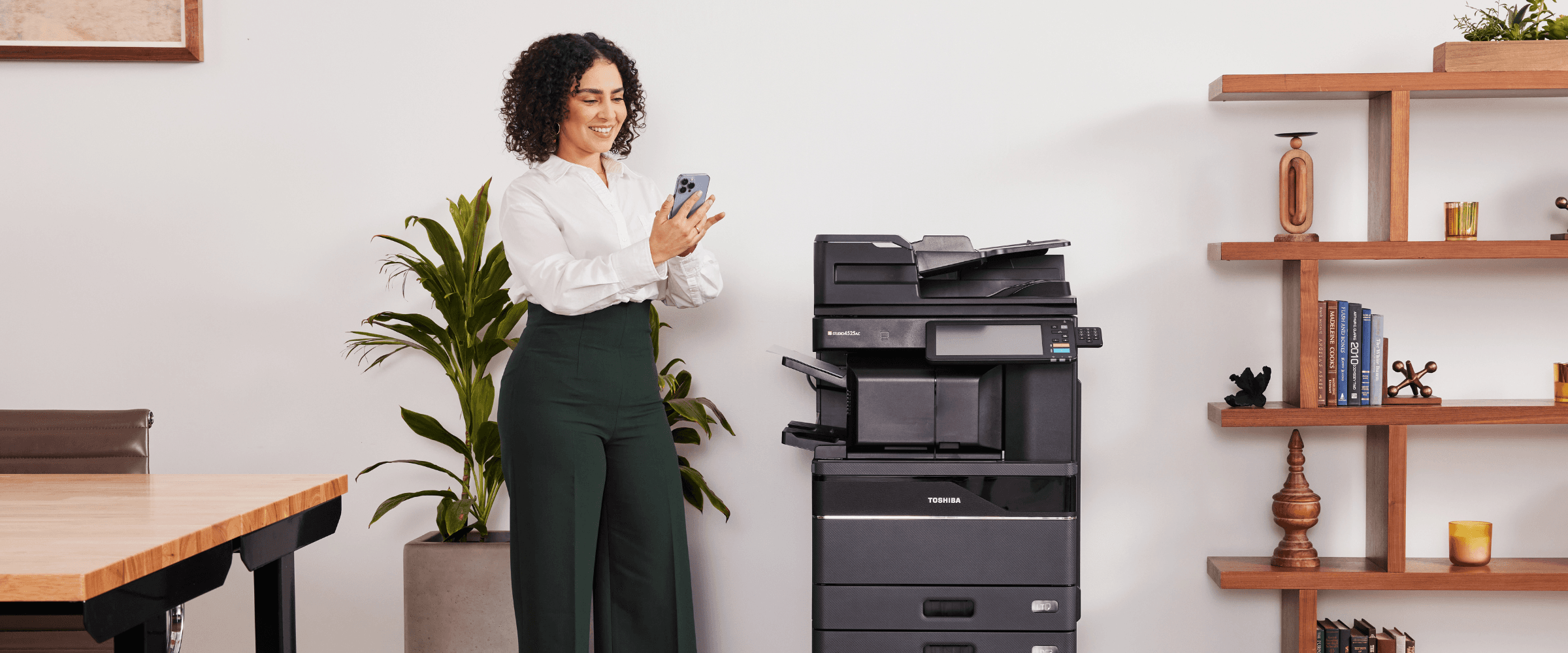 Women using smart phone to print on Toshiba MFP