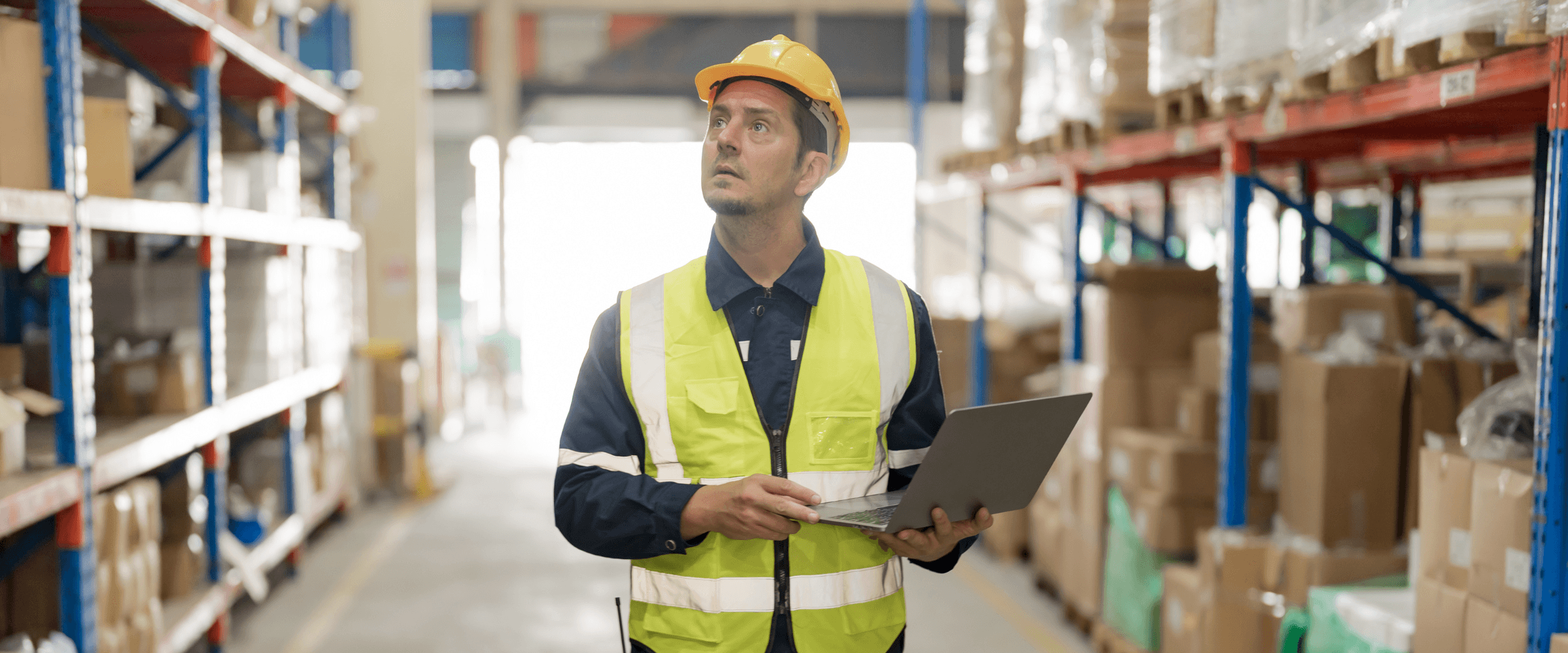 A Logistics manager walking through a warehouse.