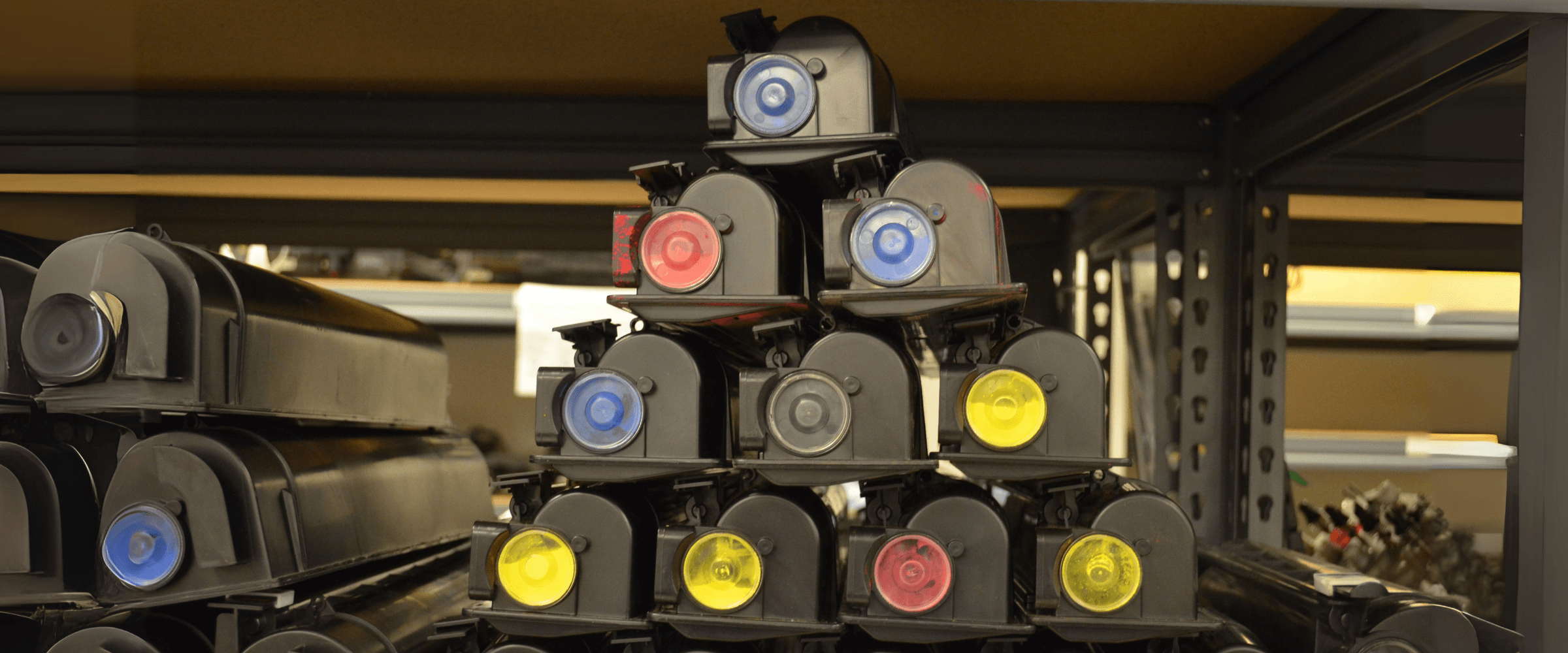 Inkjet toner stacked on a shelf.