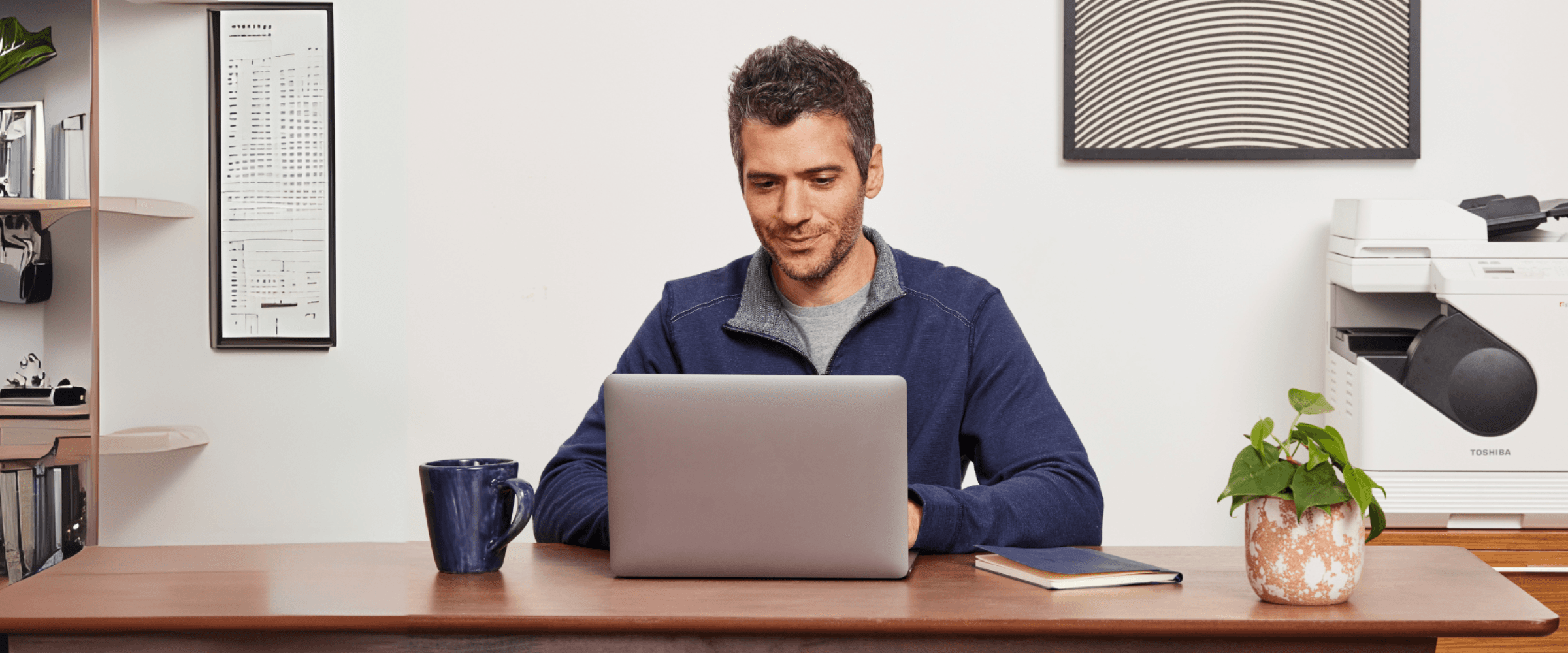 Man sitting at a computer working.