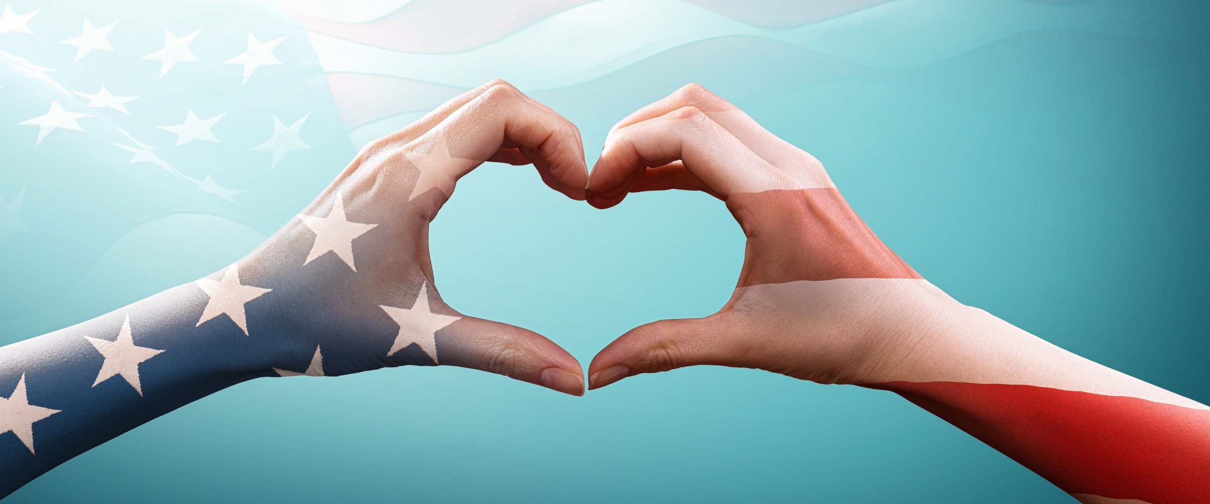 Hands making a heart shape colored as an American flag.