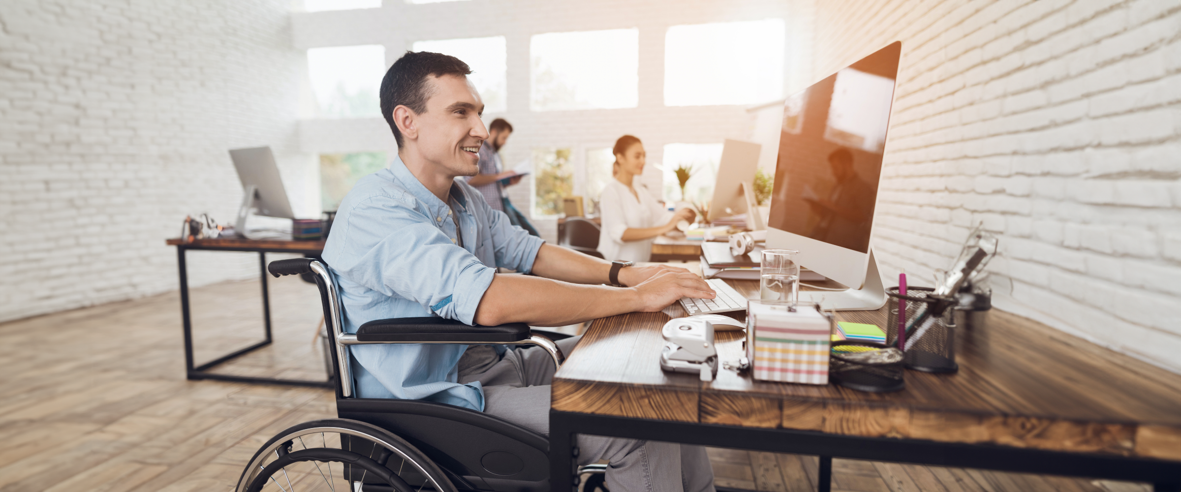 Man in wheelchair working in an office